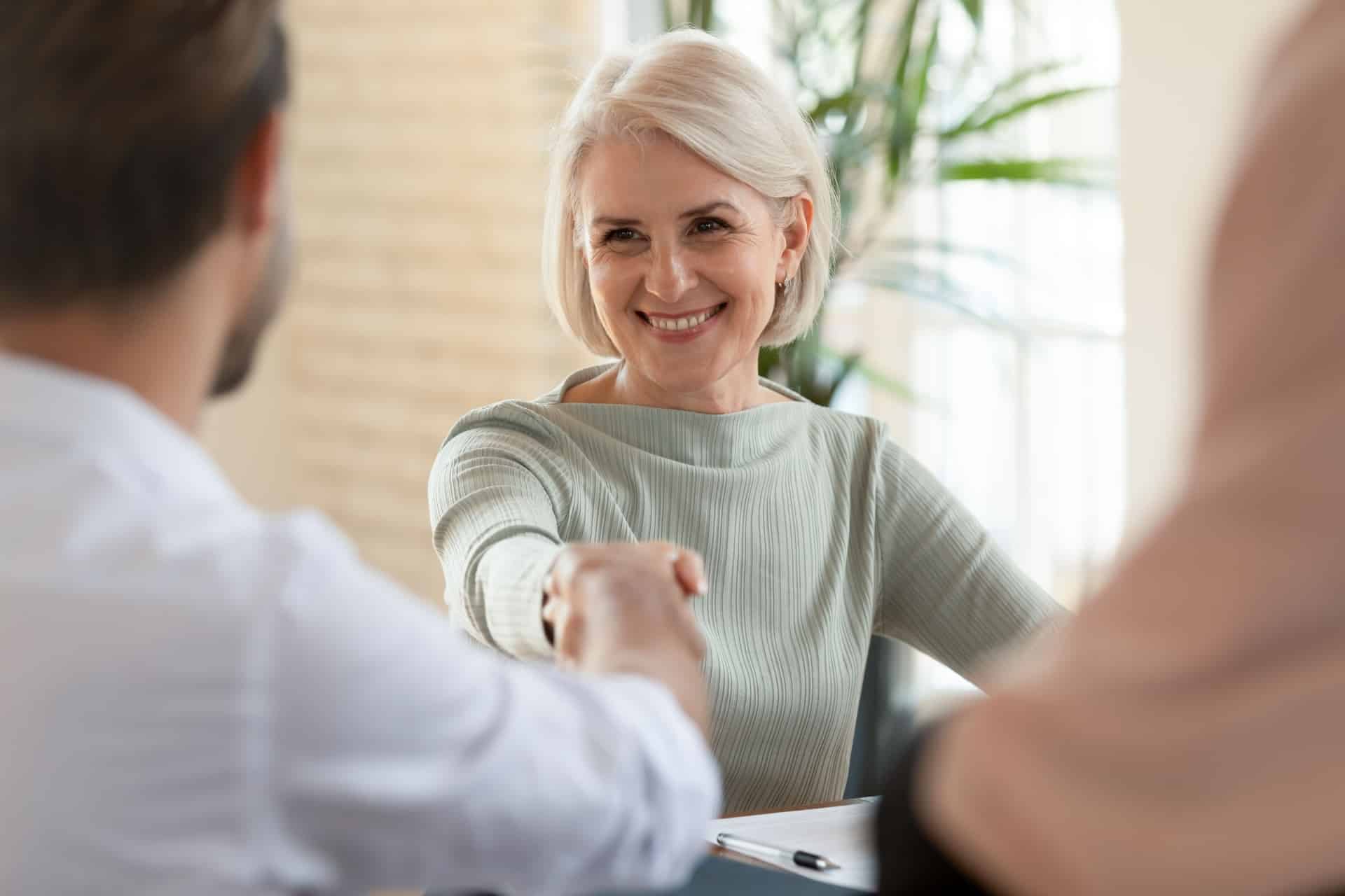 En eldre kvinne skriver testament for å symbolisere skatte- og avgiftsrett som en advokattjeneste